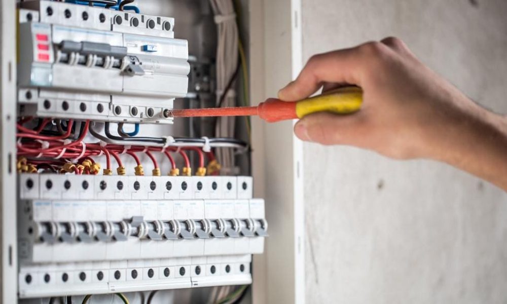 man-electrical-technician-working-switchboard-with-fuses-installation-connection-electrical-equipment-min (1)